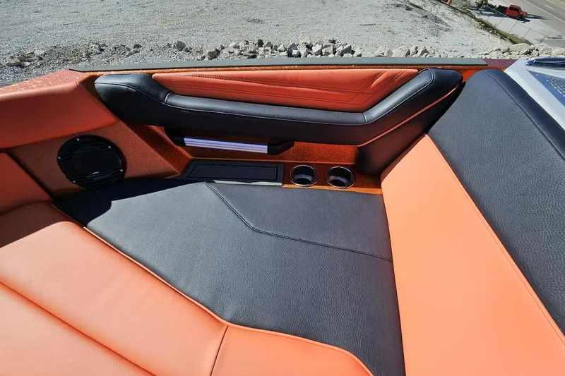 Slide: The Image of 2026 ATX Surf Boats 22 Type-S interior with orange and black seating, cup holders, and speaker. - 25