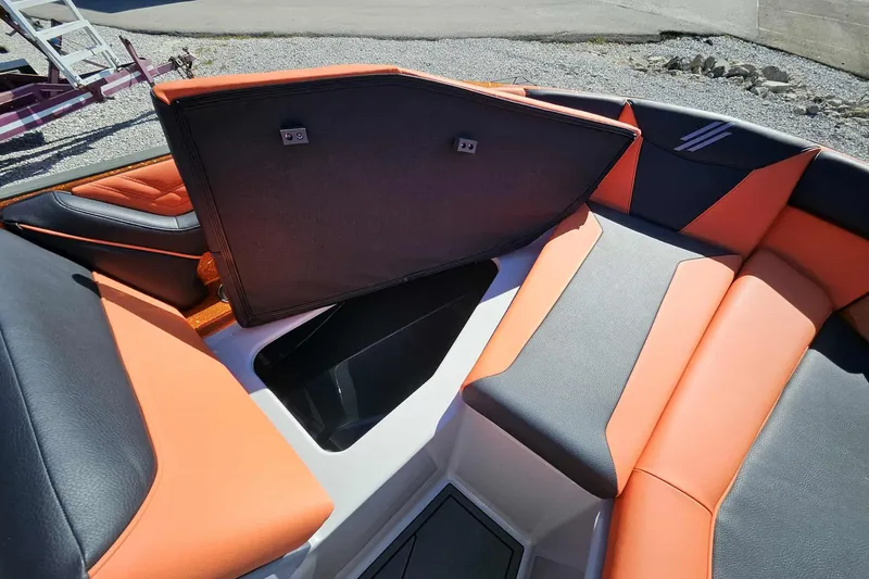 Slide: The Image of 2026 ATX Surf Boats 22 Type-S interior with orange and black seating, open storage compartment. - 27