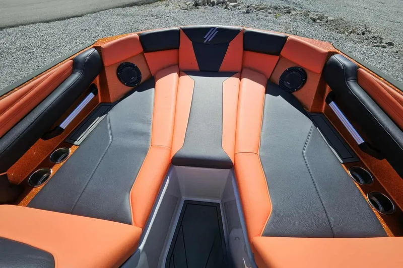 Slide: The Image of 2026 ATX Surf Boats 22 Type-S interior with orange and black seating, cup holders, and speakers. - 4