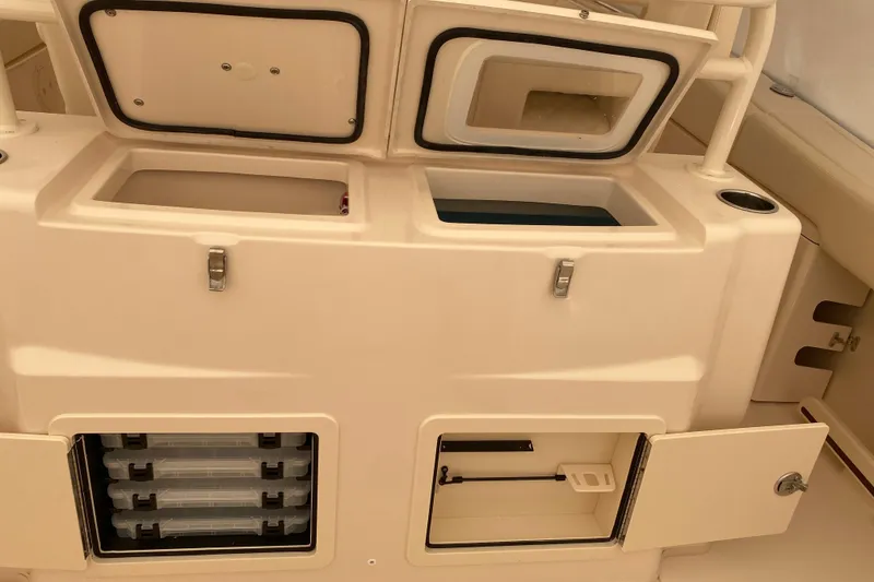 Slide: The Image of 2026 Grady-White Canyon 306 boat storage compartments and tackle boxes. - 11