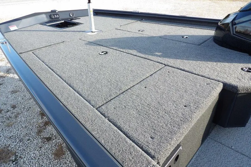 Slide: The Image of 2026 Lund 1875 Renegade boat deck with carpeted surface and storage compartments. - 10