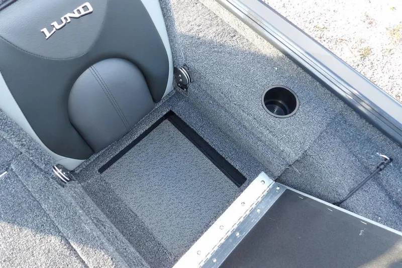 Slide: The Image of 2026 Lund 1875 Renegade boat interior with storage compartment and cup holder. - 19