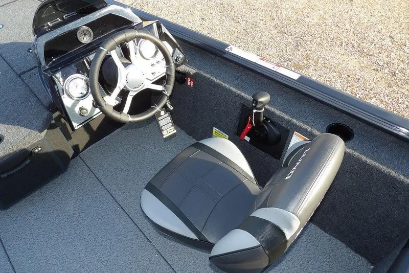 Slide: The Image of 2026 Lund 1875 Renegade boat interior with steering wheel and seat. - 23