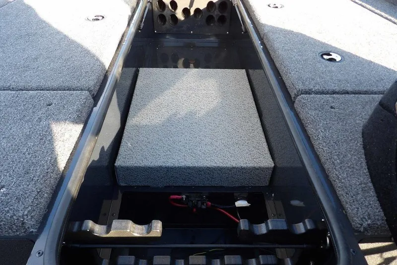 Slide: The Image of 2026 Lund 1875 Renegade boat interior with storage compartments and carpeted surfaces. - 32