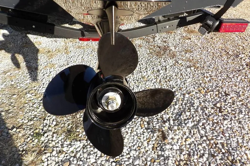 Slide: The Image of Propeller of 2026 Lund 1875 Renegade boat on gravel surface. - 35