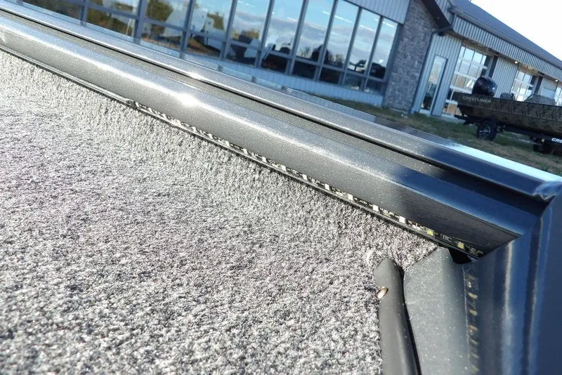 Slide: The Image of 2026 Lund 1875 Renegade boat interior detail with textured surface and metal trim. - 45