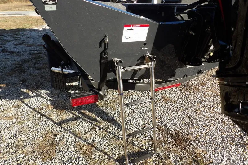 Slide: The Image of 2026 Lund 1875 Renegade boat with ladder on gravel surface. - 46