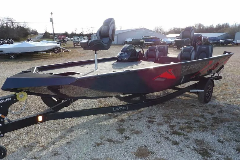 Slide: The Image of 2026 Lund 1875 Renegade fishing boat on trailer in outdoor setting. - 5