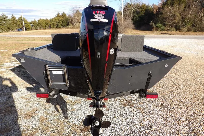 Slide: The Image of 2026 Lund 1875 Renegade boat with Mercury 115 engine, parked on gravel. - 9