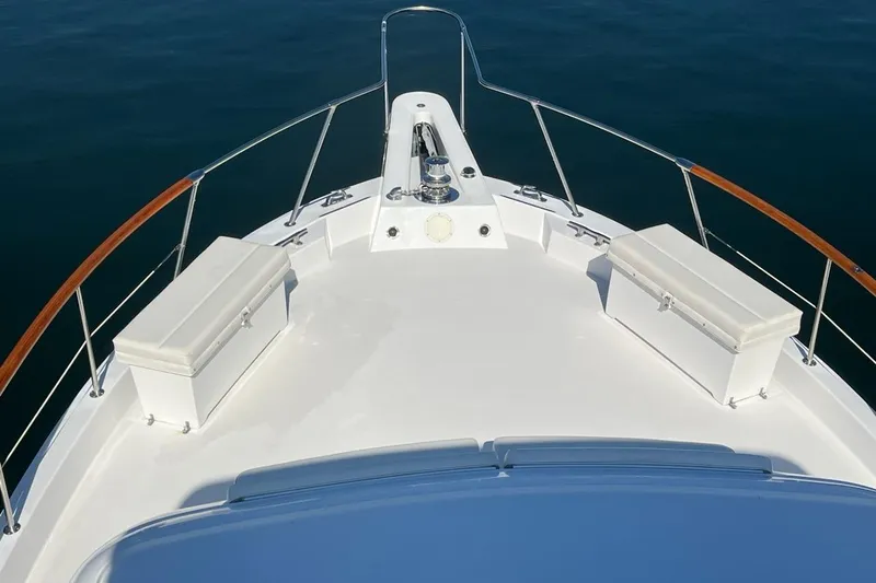 Slide: The Image of Bow view of 1985 Hatteras 58 Motor Yacht with storage boxes and railing. - 11