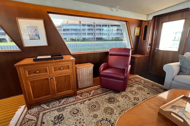 Slide: The Image of Interior of 1985 Hatteras 58 Motor Yacht with elegant wood paneling and plush seating. - 18