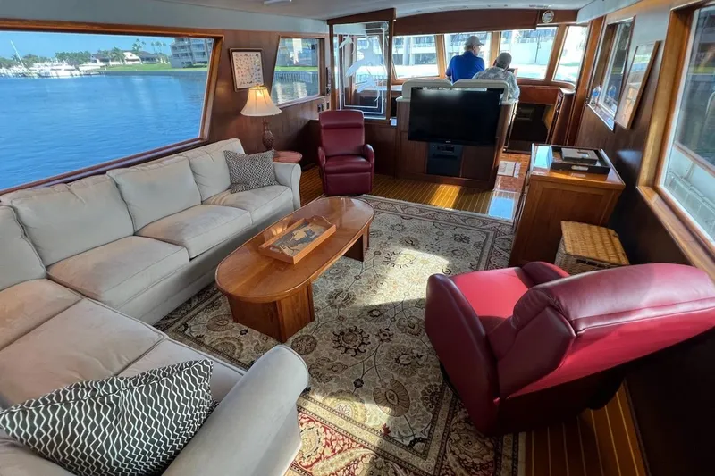 Slide: The Image of Luxurious interior of 1985 Hatteras 58 Motor Yacht with elegant seating and panoramic windows. - 19