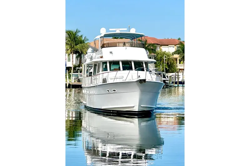 Slide: The Image of 1985 Hatteras 58 Motor Yacht on calm water, reflecting luxury and elegance. - 2