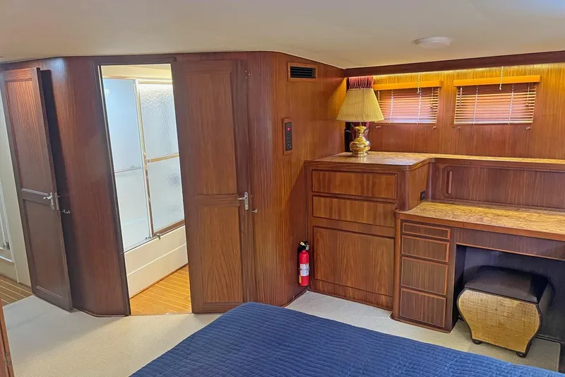 Slide: The Image of Interior of 1985 Hatteras 58 Motor Yacht with wood paneling and built-in furniture. - 26