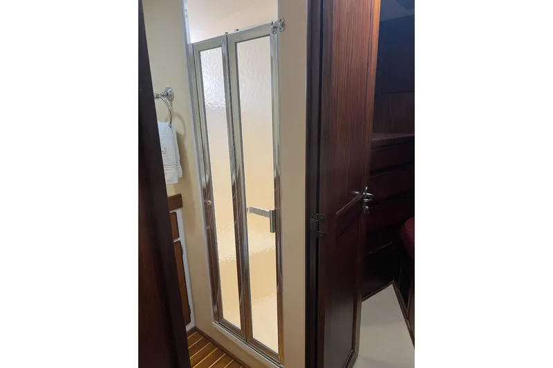 Slide: The Image of Shower area in 1985 Hatteras 58 Motor Yacht with glass door and wooden accents. - 29