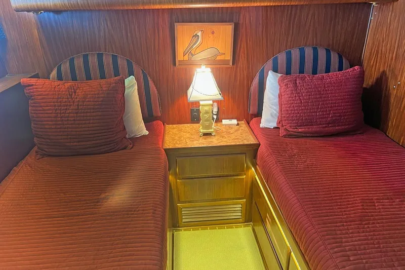 Slide: The Image of Interior of 1985 Hatteras 58 Motor Yacht with twin beds and elegant wood paneling. - 30