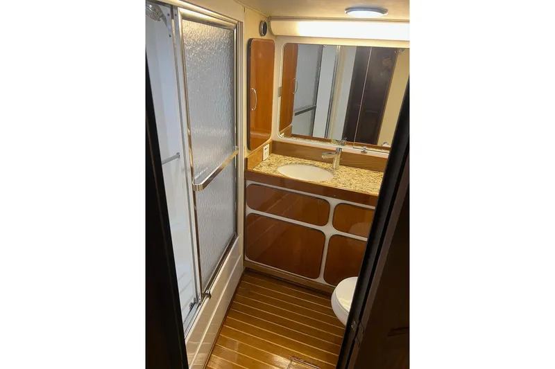 Slide: The Image of Luxurious bathroom in 1985 Hatteras 58 Motor Yacht with wood accents and modern fixtures. - 31