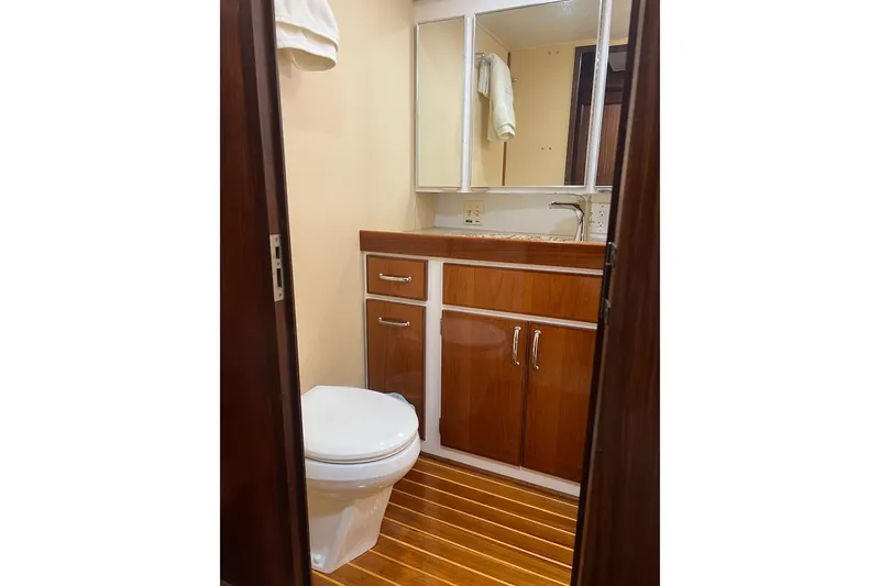 Slide: The Image of 1985 Hatteras 58 Motor Yacht bathroom with wooden cabinetry and flooring. - 34