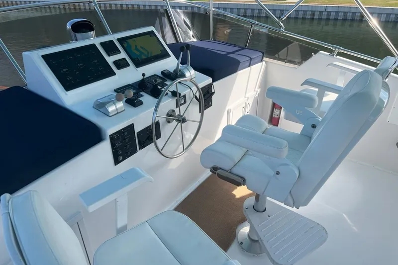 Slide: The Image of Helm of 1985 Hatteras 58 Motor Yacht with steering wheel and navigation controls. - 4