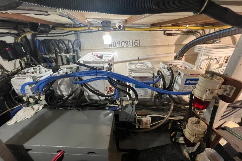 Slide: The Image of Engine room of 1985 Hatteras 58 Motor Yacht with complex wiring and equipment. - 43