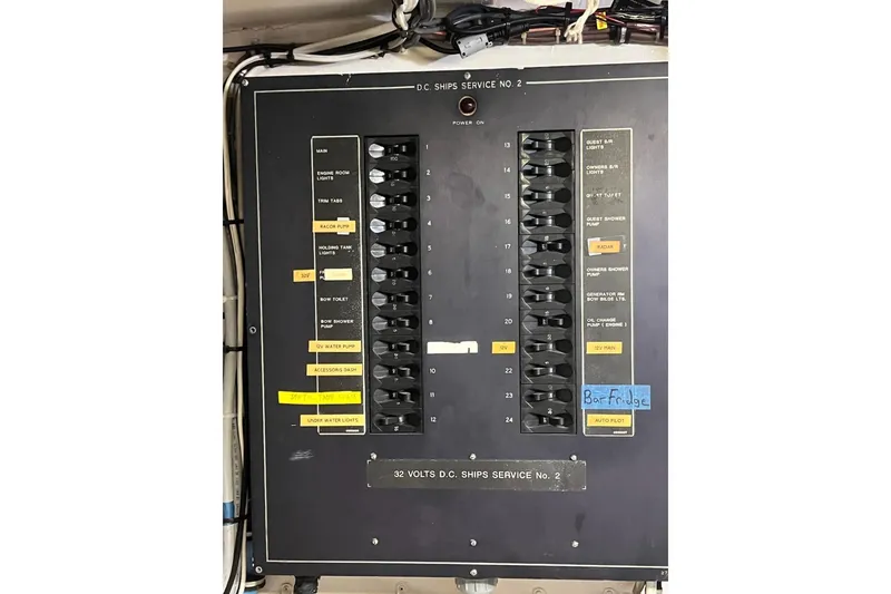 Slide: The Image of Electrical panel of a 1985 Hatteras 58 Motor Yacht with labeled switches and circuits. - 46