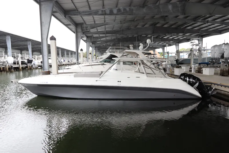 The Image of 2014 Intermarine 380 Sport boat docked under a covered marina. - 0