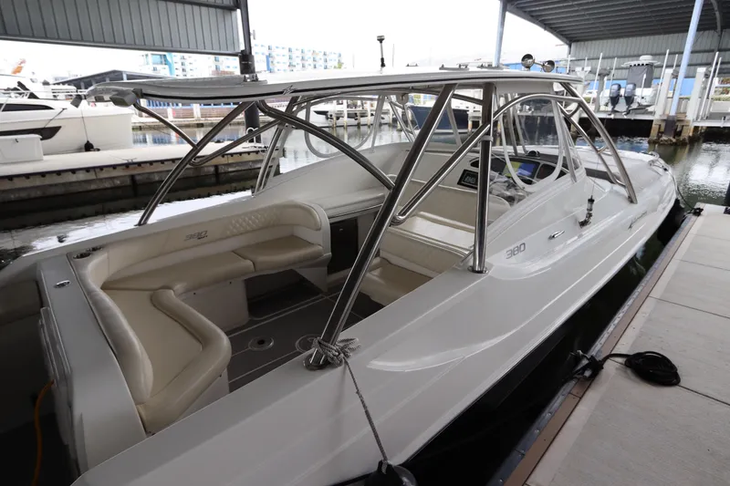 Slide: The Image of 2014 Intermarine 380 Sport boat docked in a marina, featuring sleek design and spacious seating. - 13