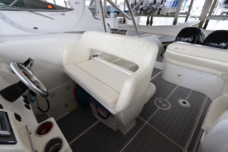 Slide: The Image of Interior of a 2014 Intermarine 380 Sport boat with white seating and steering wheel. - 18