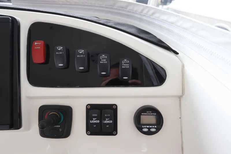 Slide: The Image of Control panel of a 2014 Intermarine 380 Sport boat with various switches and indicators. - 22