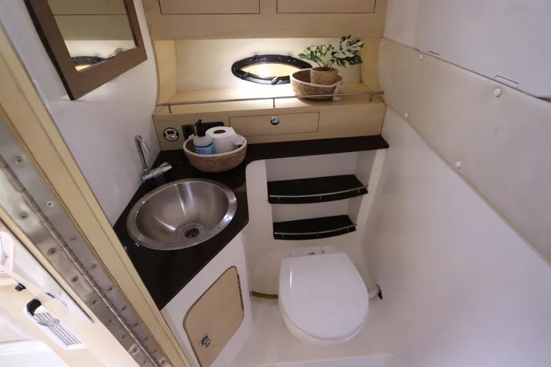 Slide: The Image of 2014 Intermarine 380 Sport yacht bathroom with sink, toilet, and storage shelves. - 31
