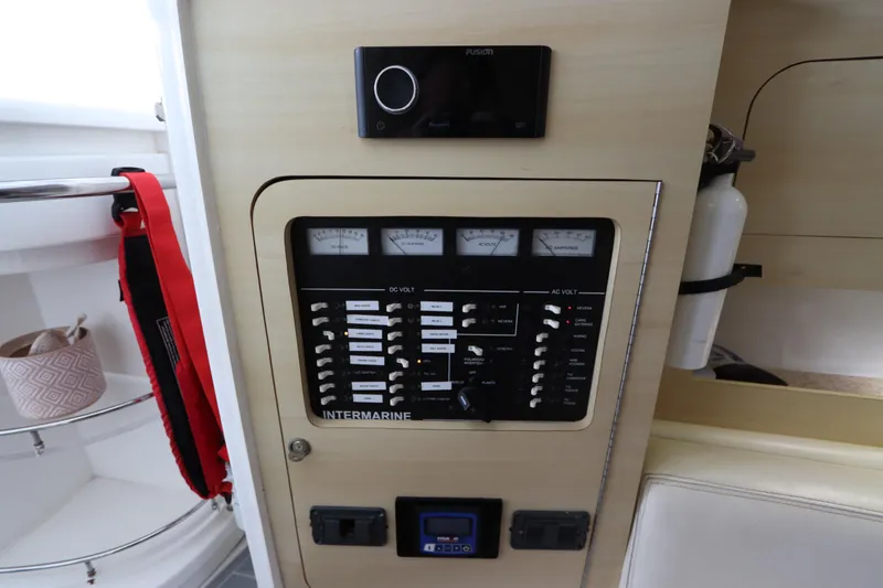 Slide: The Image of Control panel of a 2014 Intermarine 380 Sport boat, featuring various switches and gauges. - 33