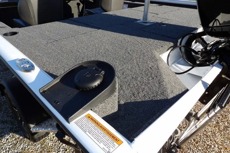 Slide: The Image of 2026 Lund 1975 Renegade boat deck with carpeted surface and motor components. - 10