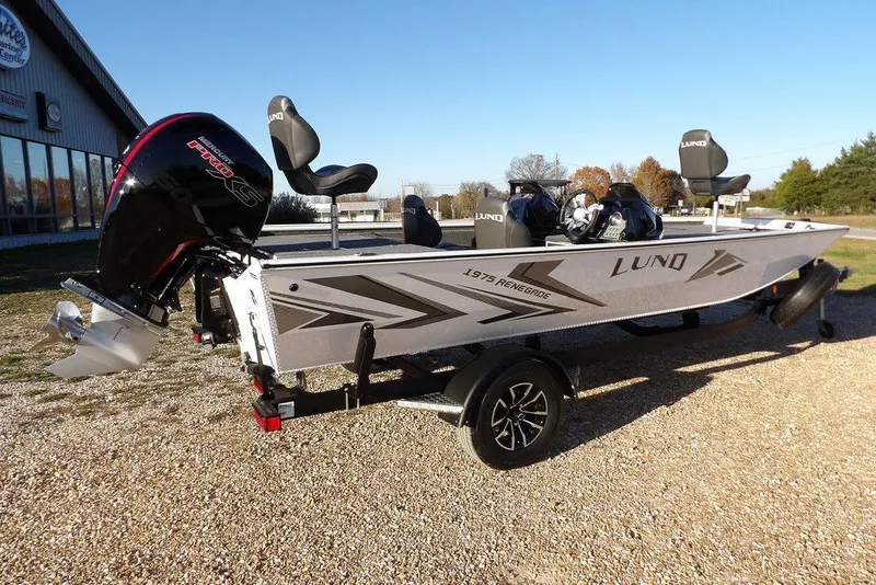 Slide: The Image of 2026 Lund 1975 Renegade boat with powerful outboard motor on a trailer. - 11