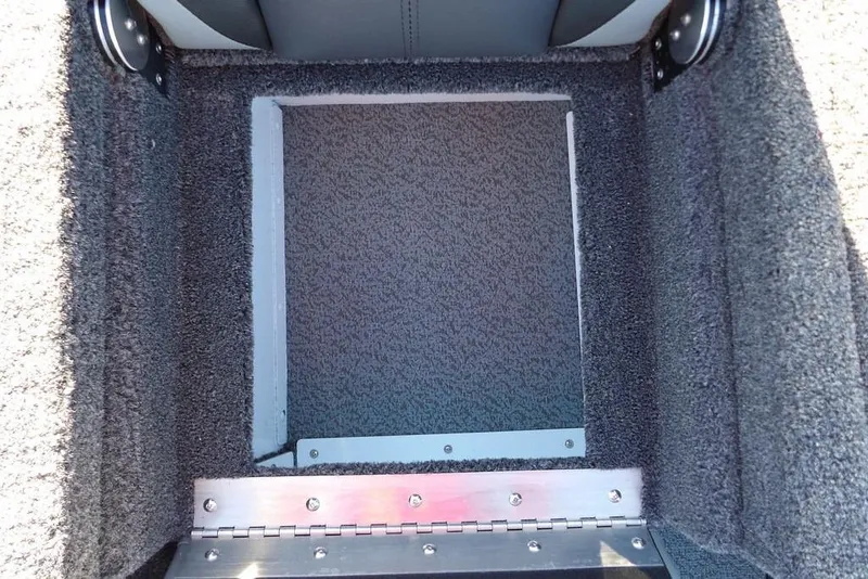 Slide: The Image of Carpeted storage compartment in a 2026 Lund 1975 Renegade boat. - 17