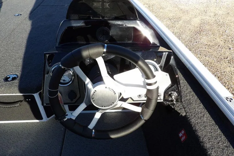 Slide: The Image of Steering wheel of 2026 Lund 1975 Renegade boat, featuring modern dashboard design. - 23