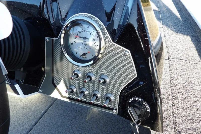 Slide: The Image of Control panel of 2026 Lund 1975 Renegade boat with RPM gauge and switches. - 24