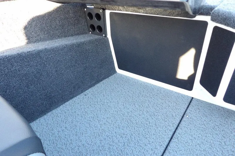 Slide: The Image of Interior of 2026 Lund 1975 Renegade boat, featuring carpeted flooring and storage compartments. - 30