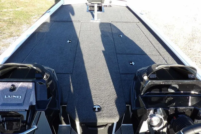 Slide: The Image of 2026 Lund 1975 Renegade boat deck with storage compartments and dual engines. - 37