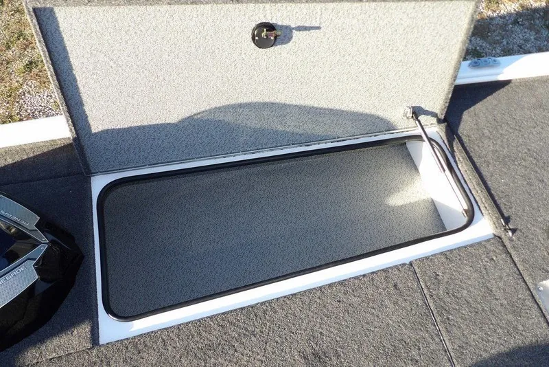 Slide: The Image of Open storage compartment on 2026 Lund 1975 Renegade boat, featuring carpeted interior. - 41
