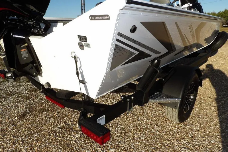 Slide: The Image of 2026 Lund 1975 Renegade boat on trailer, featuring sleek design and modern graphics. - 48