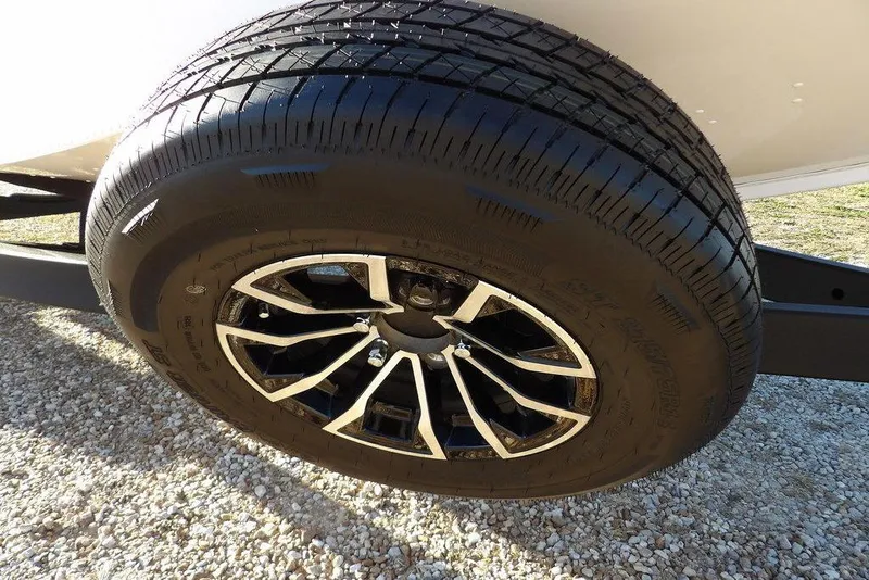Slide: The Image of Close-up of a 2026 Lund 1975 Renegade tire on gravel surface. - 49