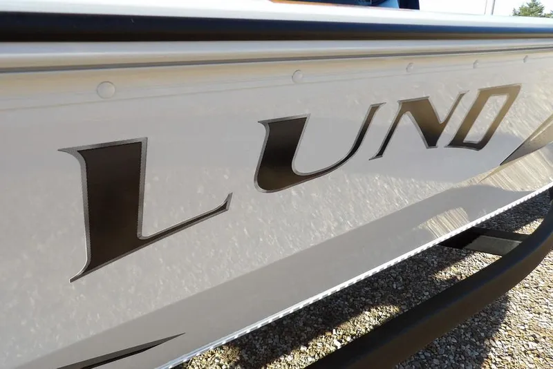 Slide: The Image of Close-up of 2026 Lund 1975 Renegade boat logo on sleek white surface. - 51