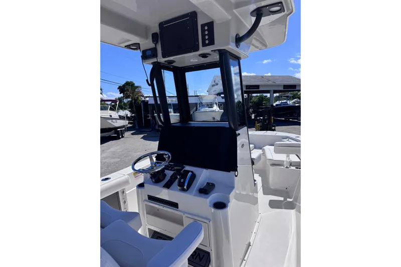 Slide: The Image of 2026 Sea Born LX24 Center Console boat interior with steering wheel and control panel. - 10