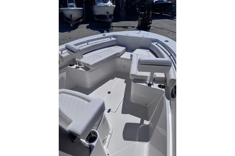 Slide: The Image of 2026 Sea Born LX24 Center Console boat interior with cushioned seating and cup holders. - 12