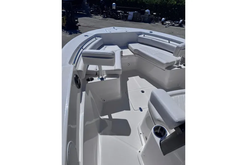 Slide: The Image of 2026 Sea Born LX24 Center Console boat interior with cushioned seating and cup holders. - 13