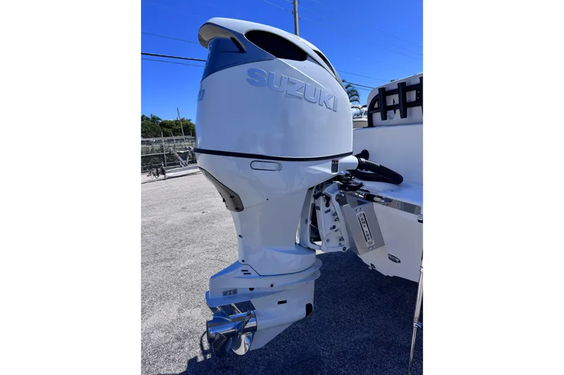 Slide: The Image of Outboard motor on 2026 Sea Born LX24 Center Console boat, sunny day. - 27