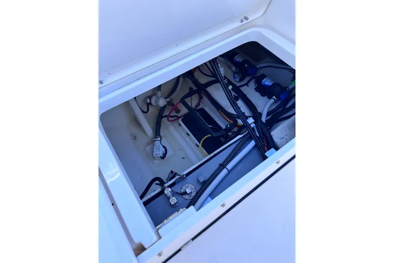 Slide: The Image of 2026 Sea Born LX24 Center Console boat wiring and components in open compartment. - 29