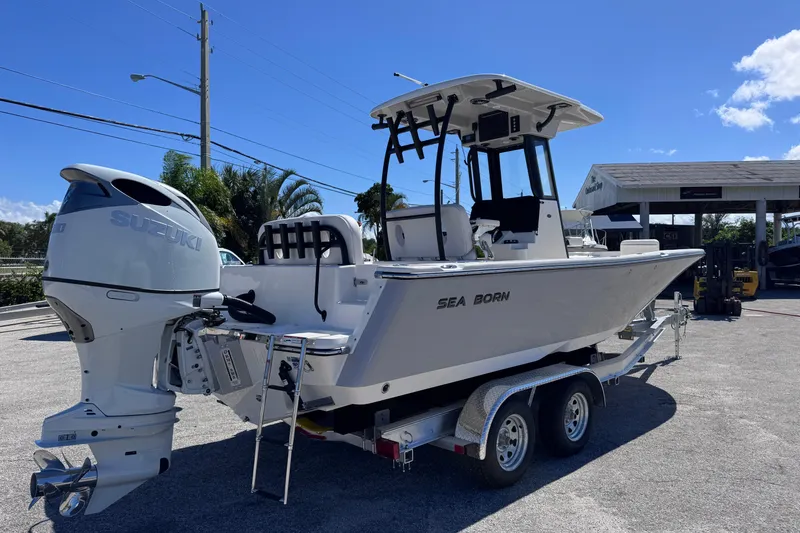 Slide: The Image of 2026 Sea Born LX24 Center Console boat on trailer, featuring Suzuki outboard motor. - 5