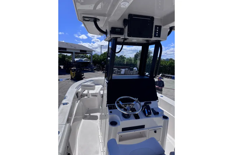 Slide: The Image of 2026 Sea Born LX24 Center Console boat interior with steering wheel and control panel. - 9