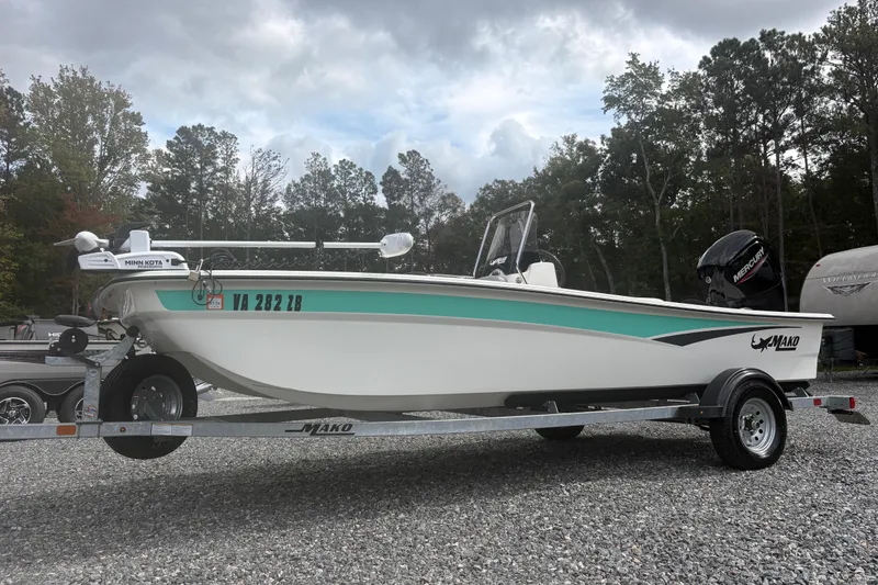 Slide: The Image of 2023 Mako Pro Skiff 17 CC boat on trailer, parked outdoors. - 1